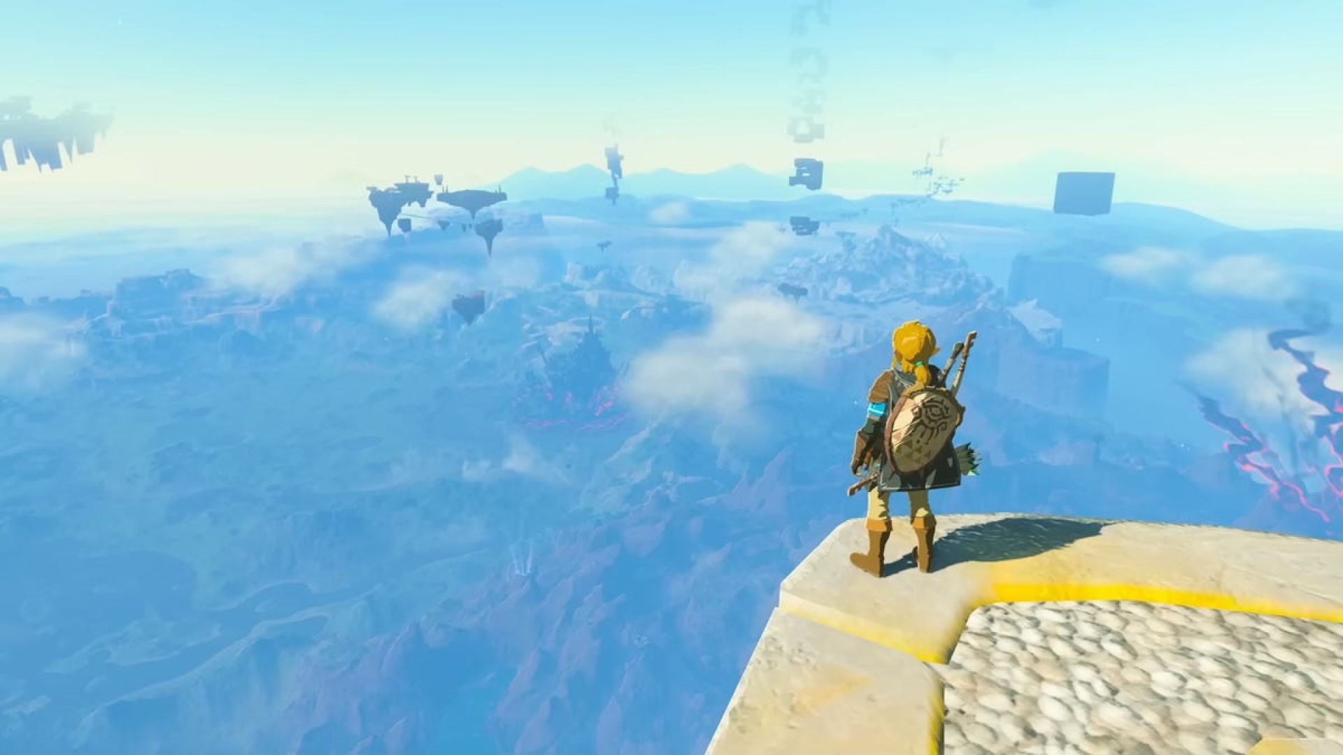Link se tenant en haut d'une montagne devant un panorama du monde